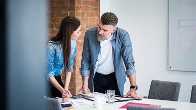 An employee and a manager in a meeting talking to each other 